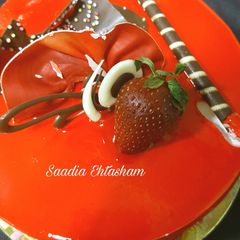 A picture of Pineapple cake with orange mirror glaze.