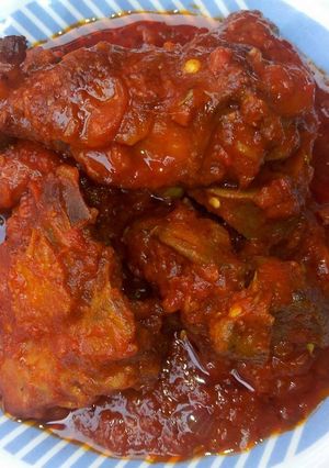 A picture of Tomato stew with chicken.