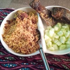 A picture of Jallof Rice and fried fish.