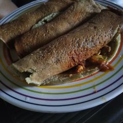 A picture of Banana pancake with vegetable sauce.