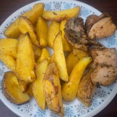 A picture of Baked Irish Potatoes and peppered chicken.