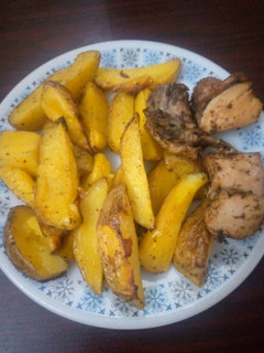 A picture of Baked Irish Potatoes and peppered chicken.