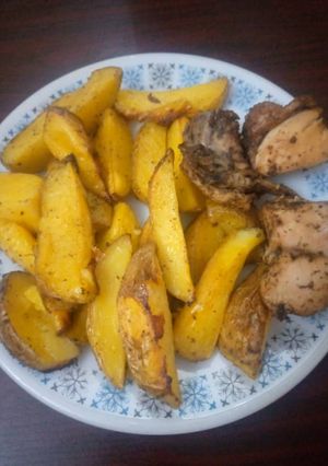 A picture of Baked Irish Potatoes and peppered chicken.