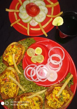 A picture of Potato boat loaded with paneer bhurji in green peas gravy.