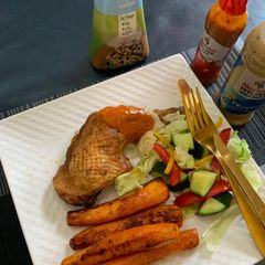 Roasted chicken,baked carrots and green salad A picture of Roasted chicken,baked carrots and green salad.
