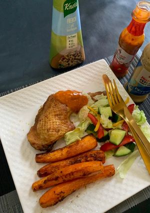A picture of Roasted chicken,baked carrots and green salad.