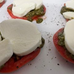 A picture of Tomato with pesto and mozzarella.