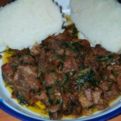 A picture of Fried meat served with ugali.
