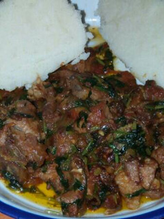 A picture of Fried meat served with ugali.