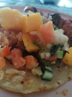 A picture of Chicken Kebabs, with cocktail rotis and fresh Mango salsa.
