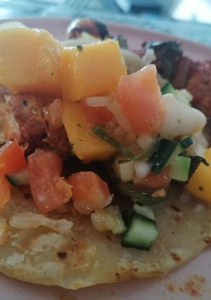 A picture of Chicken Kebabs, with cocktail rotis and fresh Mango salsa.