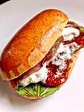 Maritozzo con Pomodori Secchi Burrata Filetti di Alici e Basilico