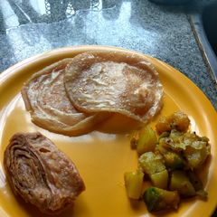 Puri and potato curry (luchi torkari) A picture of Puri and potato curry (luchi torkari).