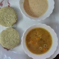 A picture of Green idli with samber and peanut chutney.