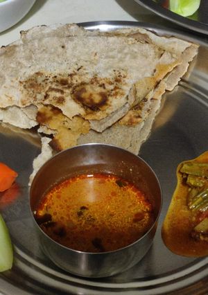 A picture of Sorgam bhakri (flat bread) with ridge gourd and potato sabji.