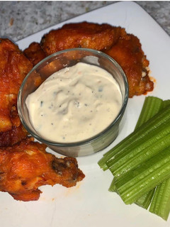 A picture of Buffalo Wings with home-made Blue Cheese Dip.