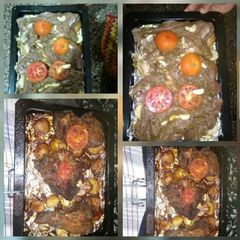 A picture of Baked and roasted beef steaks some roast potatoes and tomatos.