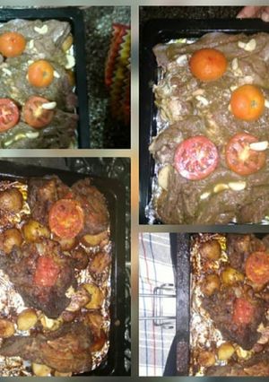 A picture of Baked and roasted beef steaks some roast potatoes and tomatos.