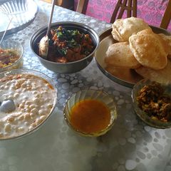 A picture of Aloo ki kachori, puri, raw mango pethe ki sabzi, launji, boondi.