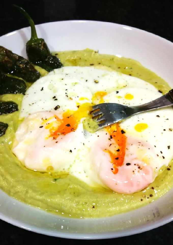 Una foto de Huevos fritos sobre puré de guisantes secos