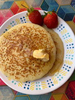 A picture of Original fluffy pancake with honey, butter and strawberry.