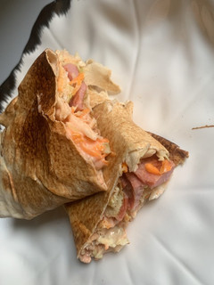 A picture of Sausage and egg shawarma.