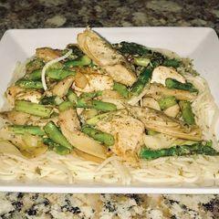 A picture of Jerusalem chicken, grilled artichoke hearts, Asparagus on top of angel hair pasta.