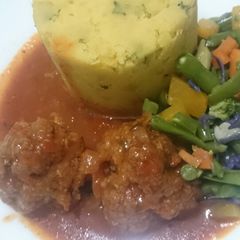 A picture of Mashed sweet potatoes and meatballs.
