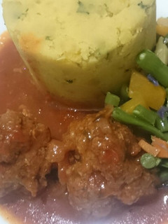 A picture of Mashed sweet potatoes and meatballs.