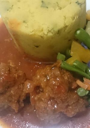 A picture of Mashed sweet potatoes and meatballs.