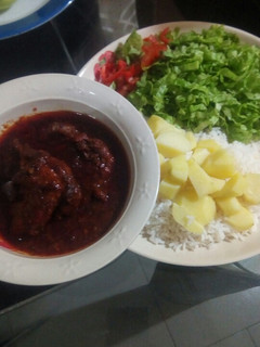 A picture of White rice,potatoes, stew and salad.