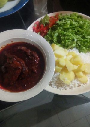 A picture of White rice,potatoes, stew and salad.