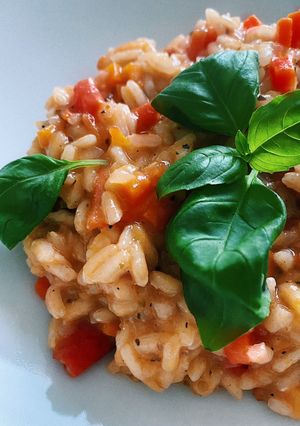 A picture of Risotto with tomatoes, carrots and oranges 🍊.