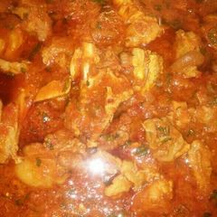 A picture of Shredded chicken stew with iru n basil leave.