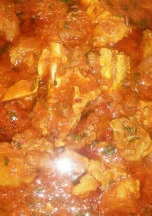 A picture of Shredded chicken stew with iru n basil leave.
