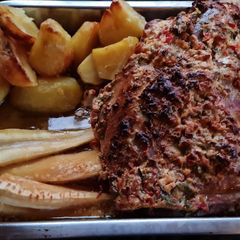 A picture of Roast shoulder of lamb in a spicy soured cream crust.