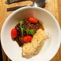 A picture of Rice Mayai served with lentils.