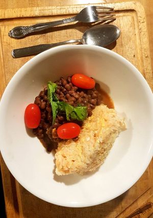 A picture of Rice Mayai served with lentils.