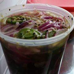 A picture of Pickled red onions with jalapenos.