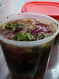 A picture of Pickled red onions with jalapenos.