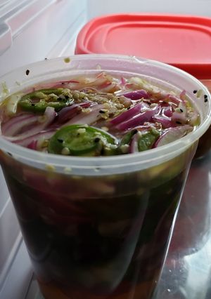 A picture of Pickled red onions with jalapenos.