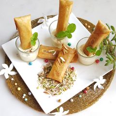 Moong Dal Halwa Cigars dipped in Shaahi Rabdi A picture of Moong Dal Halwa Cigars dipped in Shaahi Rabdi.