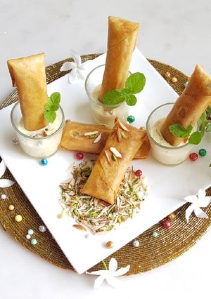 A picture of Moong Dal Halwa Cigars dipped in Shaahi Rabdi.