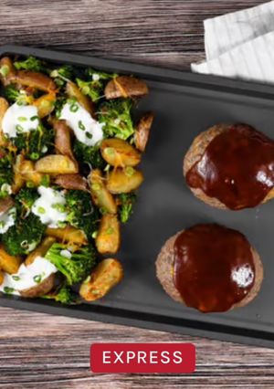 A picture of HC- Sheet Pan Cheddar-Jack BBQ Meatloaf with roasted loaded potatoes and broccoli.