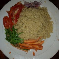 A picture of Indomie noodles with assorted veggies.