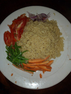 A picture of Indomie noodles with assorted veggies.