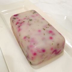 A picture of Agidi infused with red cabbage and ugu leaves.