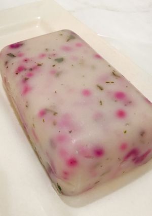 A picture of Agidi infused with red cabbage and ugu leaves.