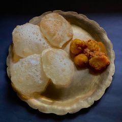 A picture of Phulko Luchi o Thakurbari style Aloo Dum Bengali style.