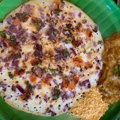 A picture of Pizza style Onion and Tomato Uthappam.